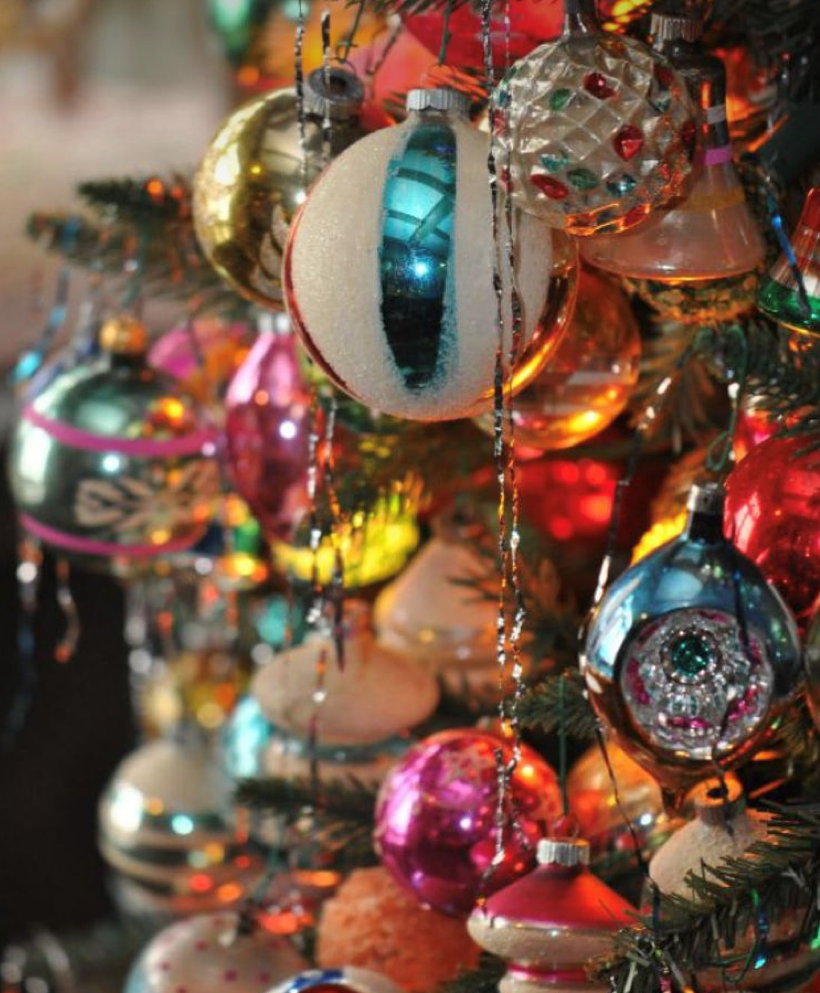 This year's Christmas decoration trends colourful glass retro baubles hanging from the Christmas tree 