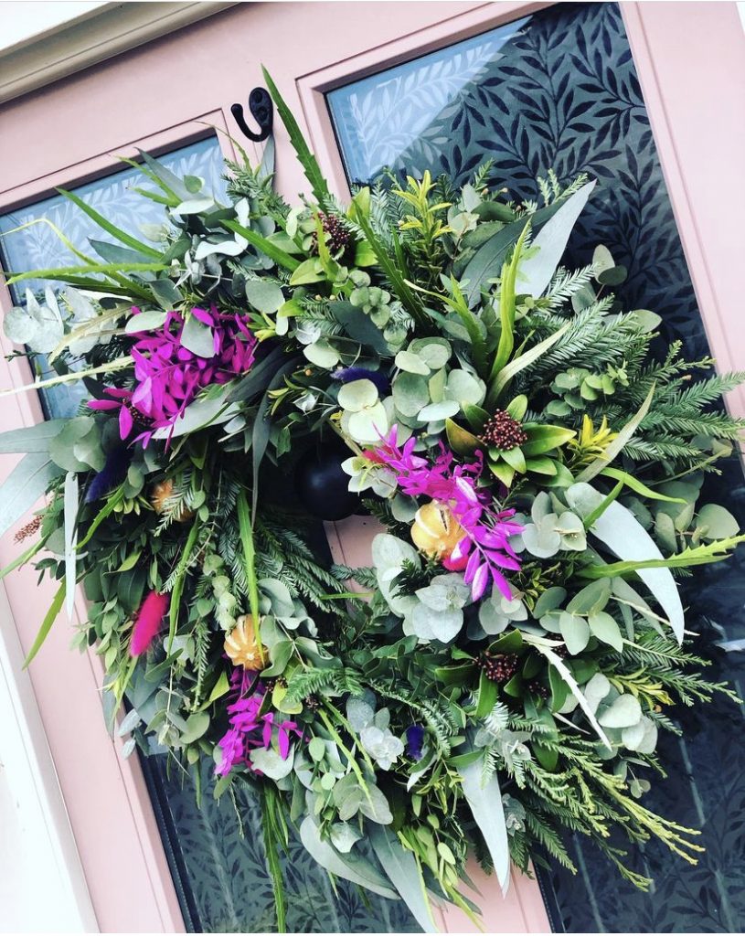 Beautiful Christmas wreath with a shock of bright pink flowers