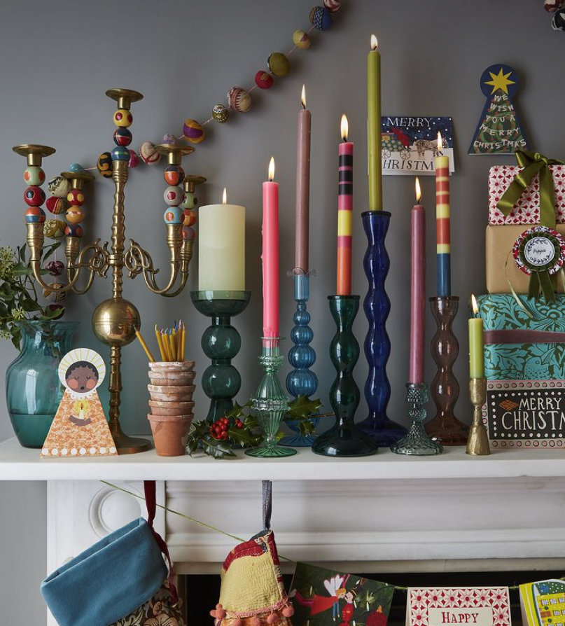 Colourful glass candle sticks with contrasting brightly coloured candles are a must for this years best Christmas decoration trends